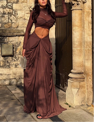 Woman in a burgundy dress standing in front of a stone building