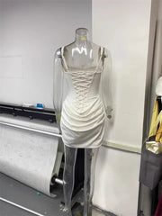 White dress on a mannequin in a room with a printer and other items- back details