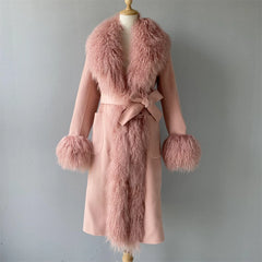 Pink coat with fur trim on a mannequin against a gray background