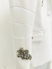 Close-up of a white coat with a decorative brooch