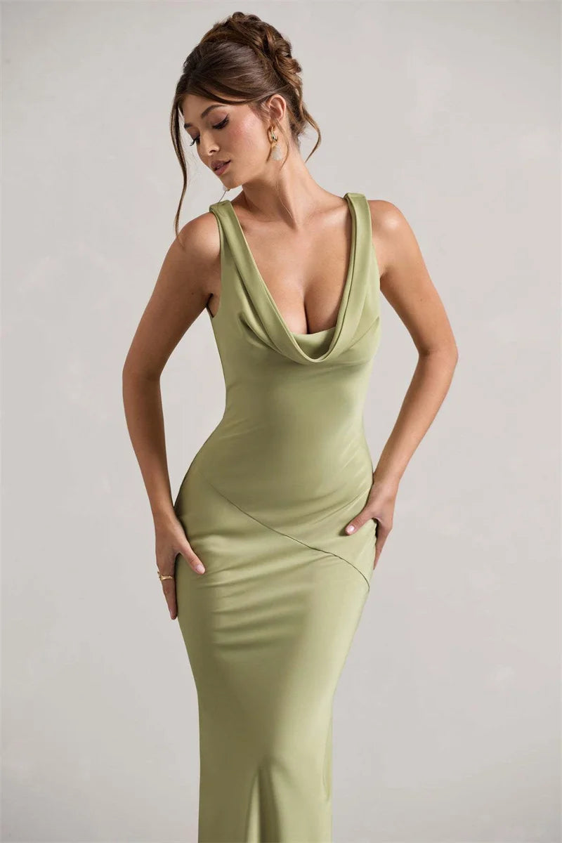 Woman wearing a green dress against a plain background