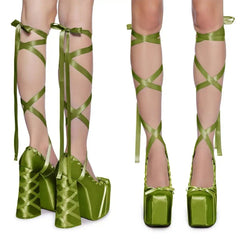 Green platform shoes with ribbons on a white background