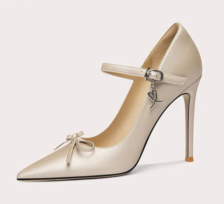 Beige high-heeled shoe with a bow detail on a white background
