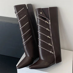 Pair of brown knee-high boots with silver zippers on a white surface.