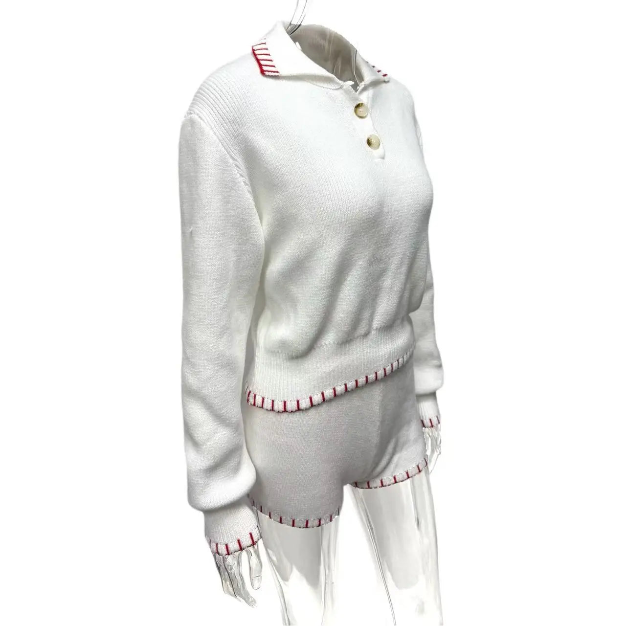 White sweater with red trim on a white background