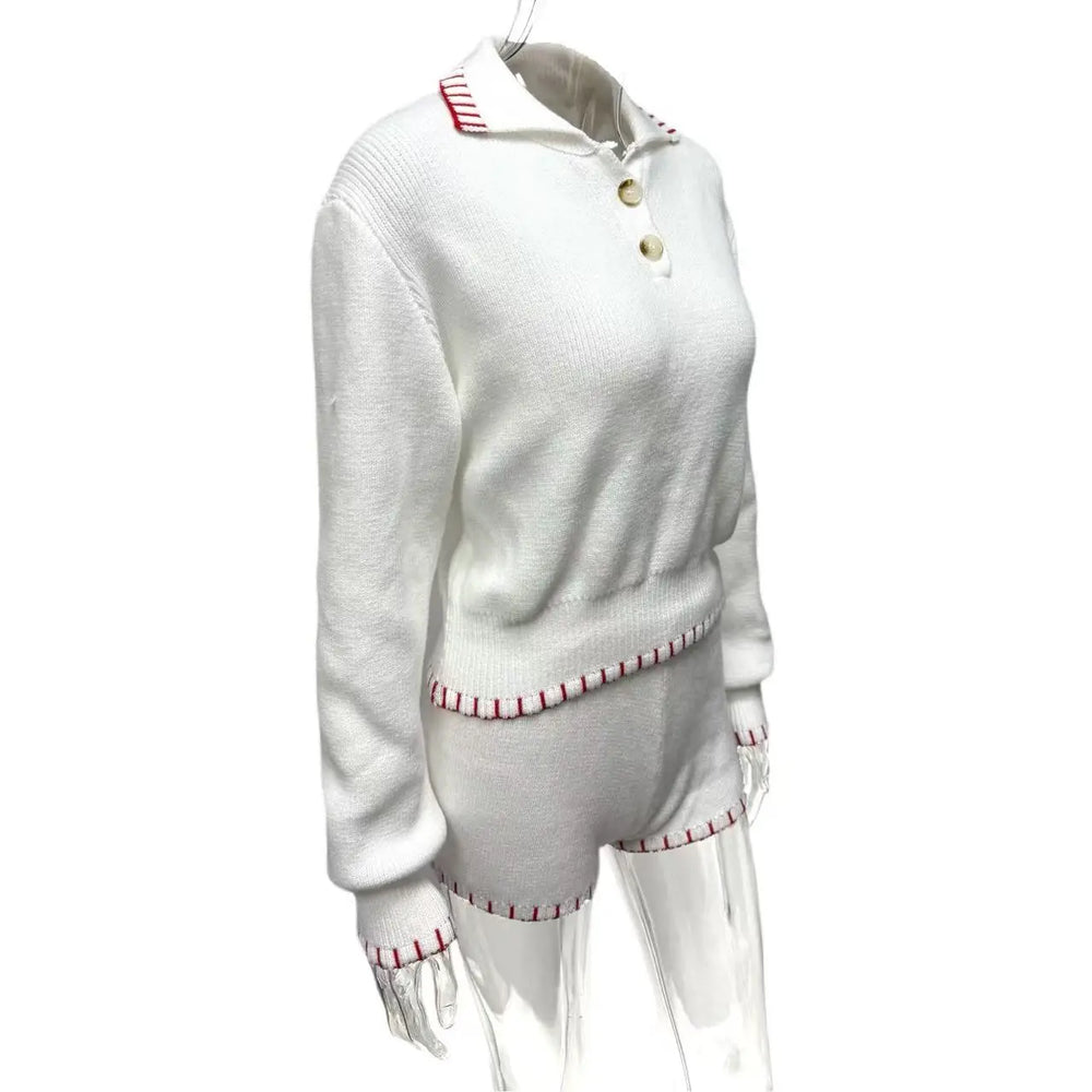 White sweater with red trim on a white background