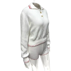 White sweater with red trim on a white background