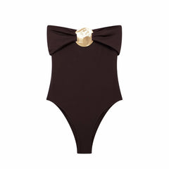 Brown swimsuit with a gold bow on a white background