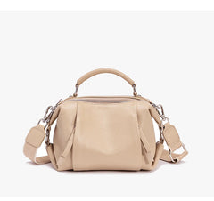 Beige handbag with a shoulder strap on a white background