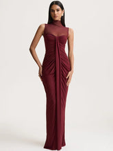 Woman wearing a burgundy evening gown on a white background