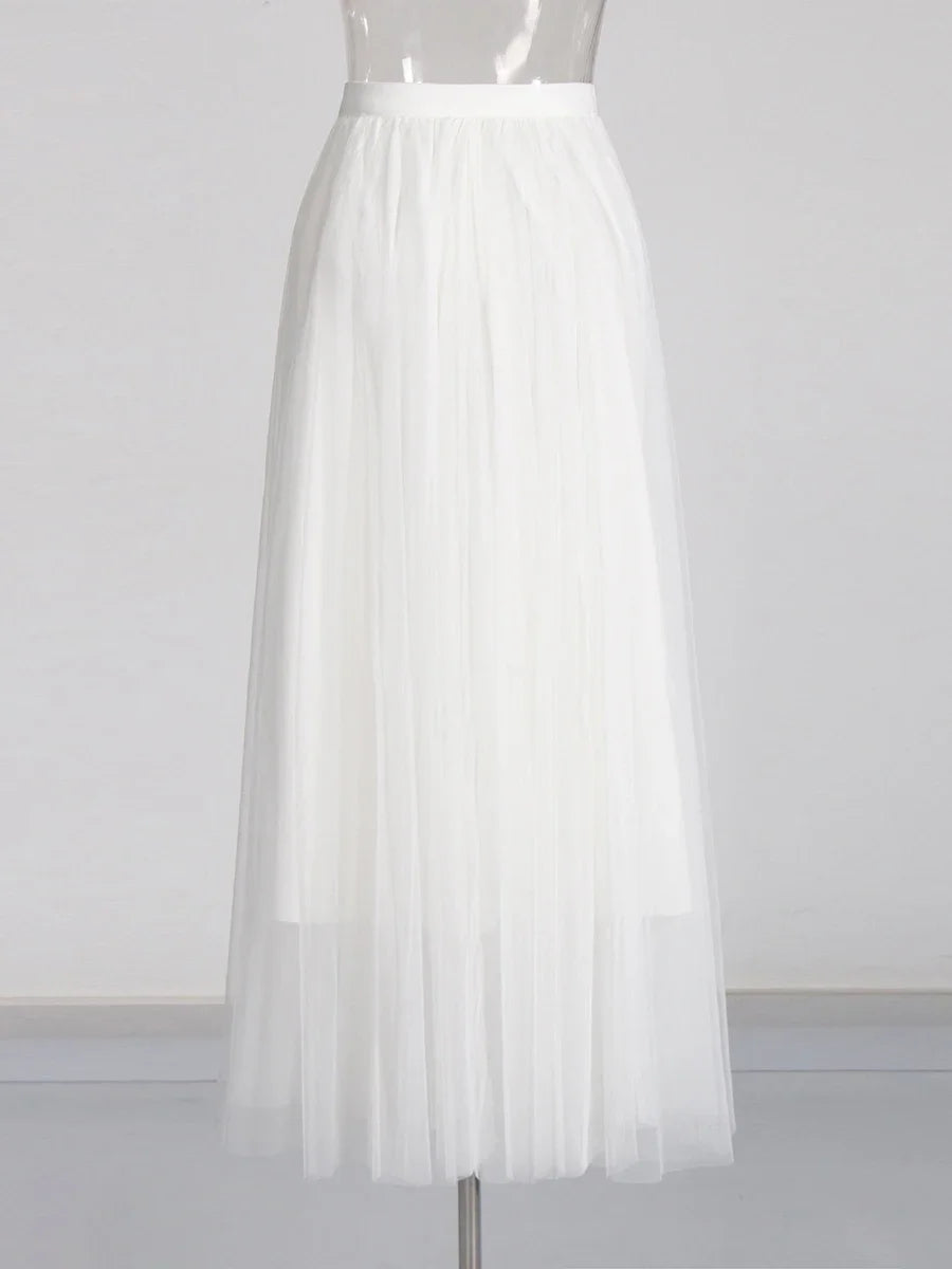 White pleated skirt on a mannequin against a white background