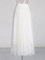 White pleated skirt on a mannequin against a white background