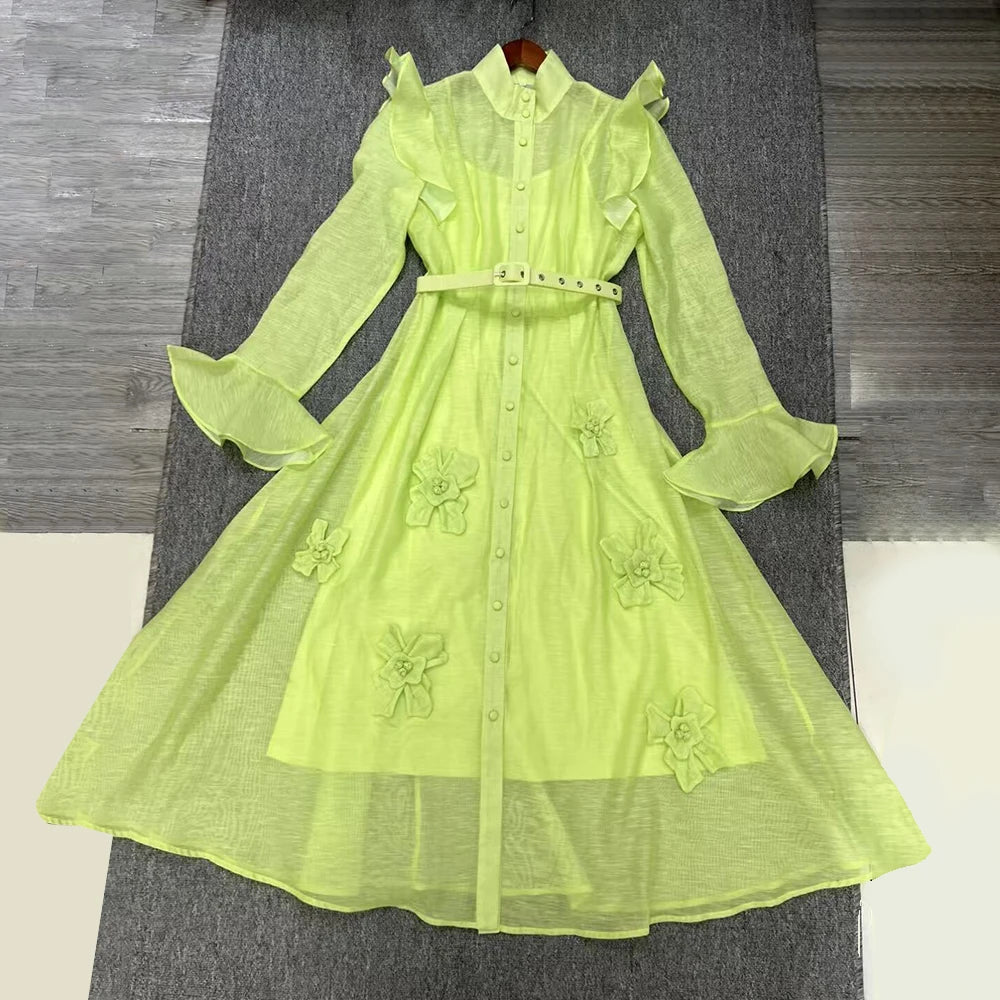 Light green dress with floral embroidery on a textured surface