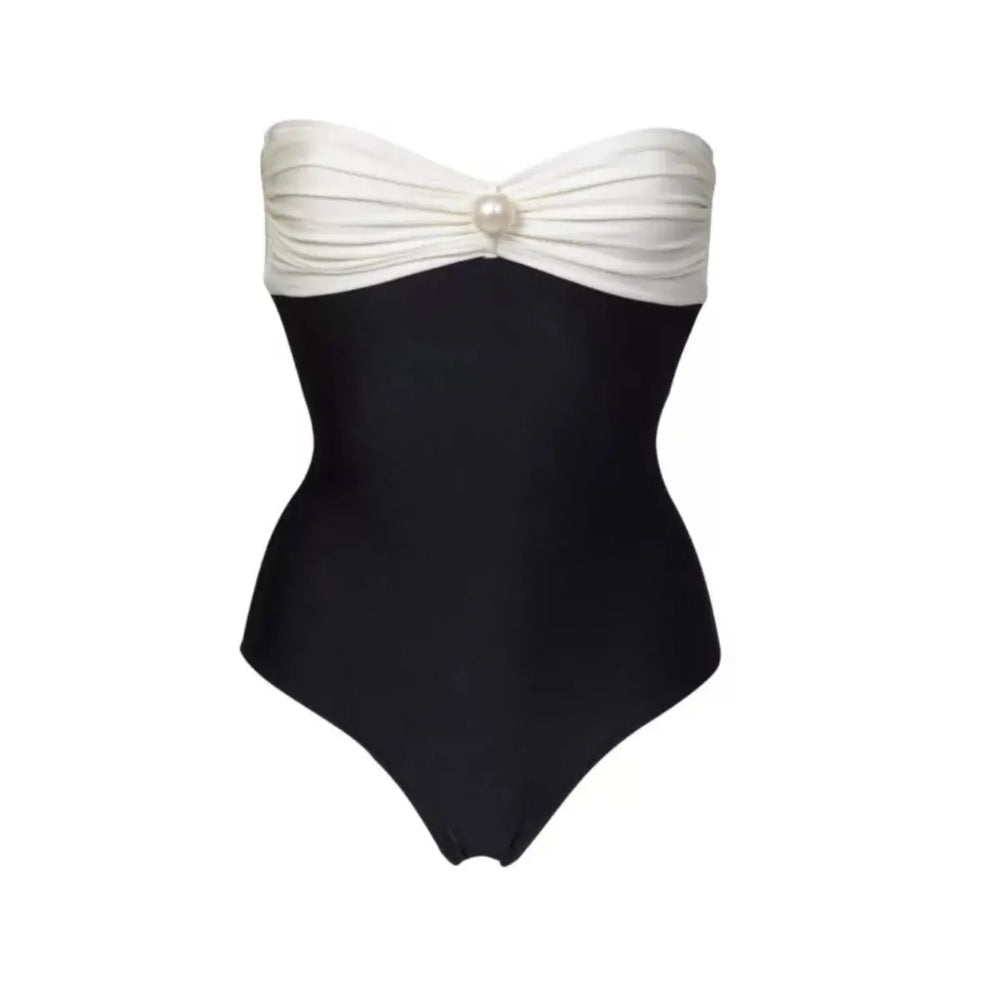 Close-up of a black and white bandeau swimsuit with a single pearl accent