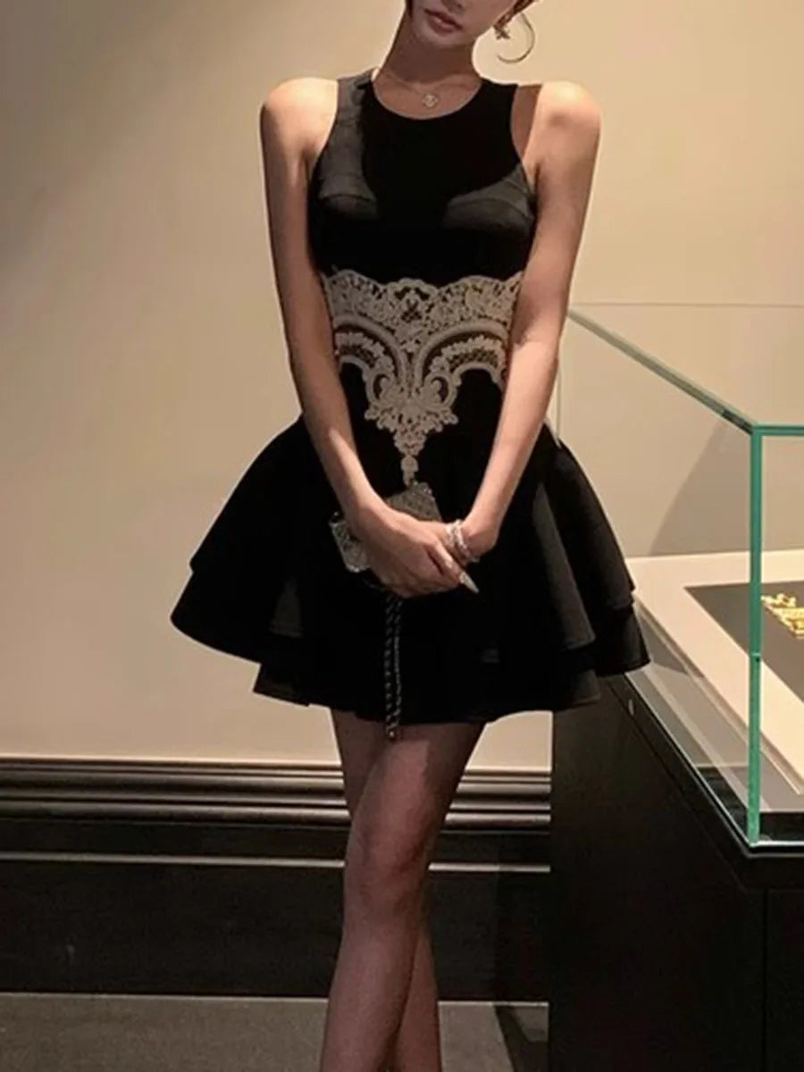 Black dress with lace detailing worn by a person indoors.