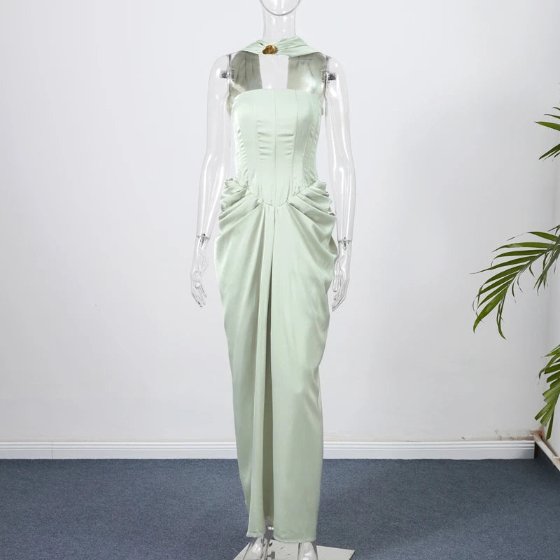 Light green evening gown on a mannequin against a white wall.