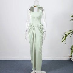 Light green evening gown on a mannequin against a white wall.