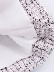 Close-up of textured fabric with a patterned edge on a light background