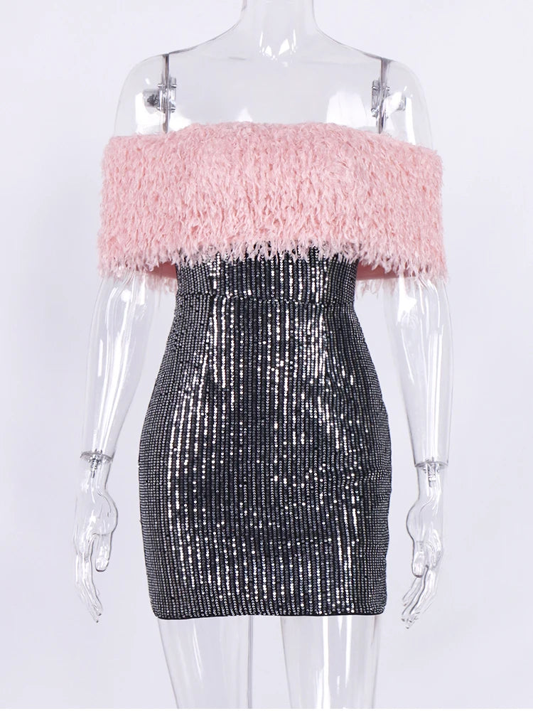 Mannequin wearing a dress with pink fluffy top and black sequin skirt on a white background