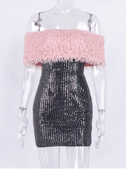 Mannequin wearing a dress with pink fluffy top and black sequin skirt on a white background