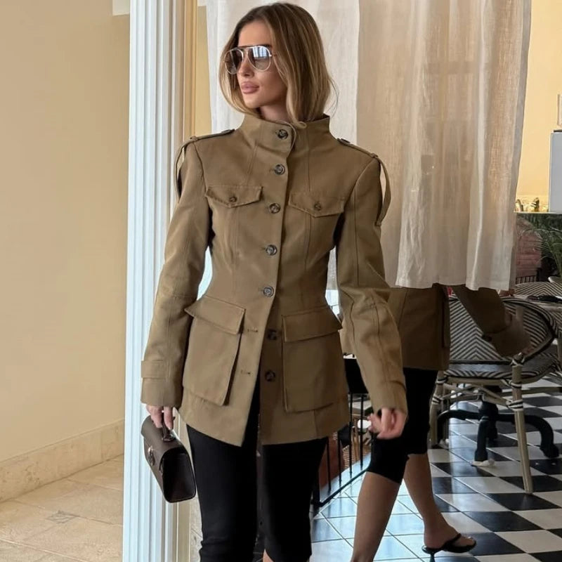 Woman wearing a beige trench coat in an indoor setting