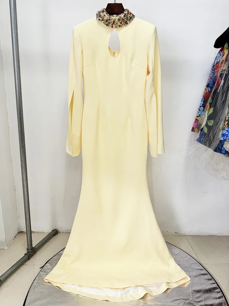 Front view of yellow maxi dress with cape sleeves and beaded neckline