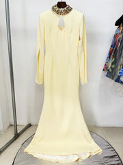 Front view of yellow maxi dress with cape sleeves and beaded neckline