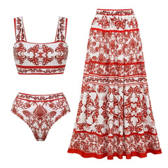 Flat lay of a two-piece swimsuit set including a crop top, bikini bottom, and maxi skirt with red and white pattern.