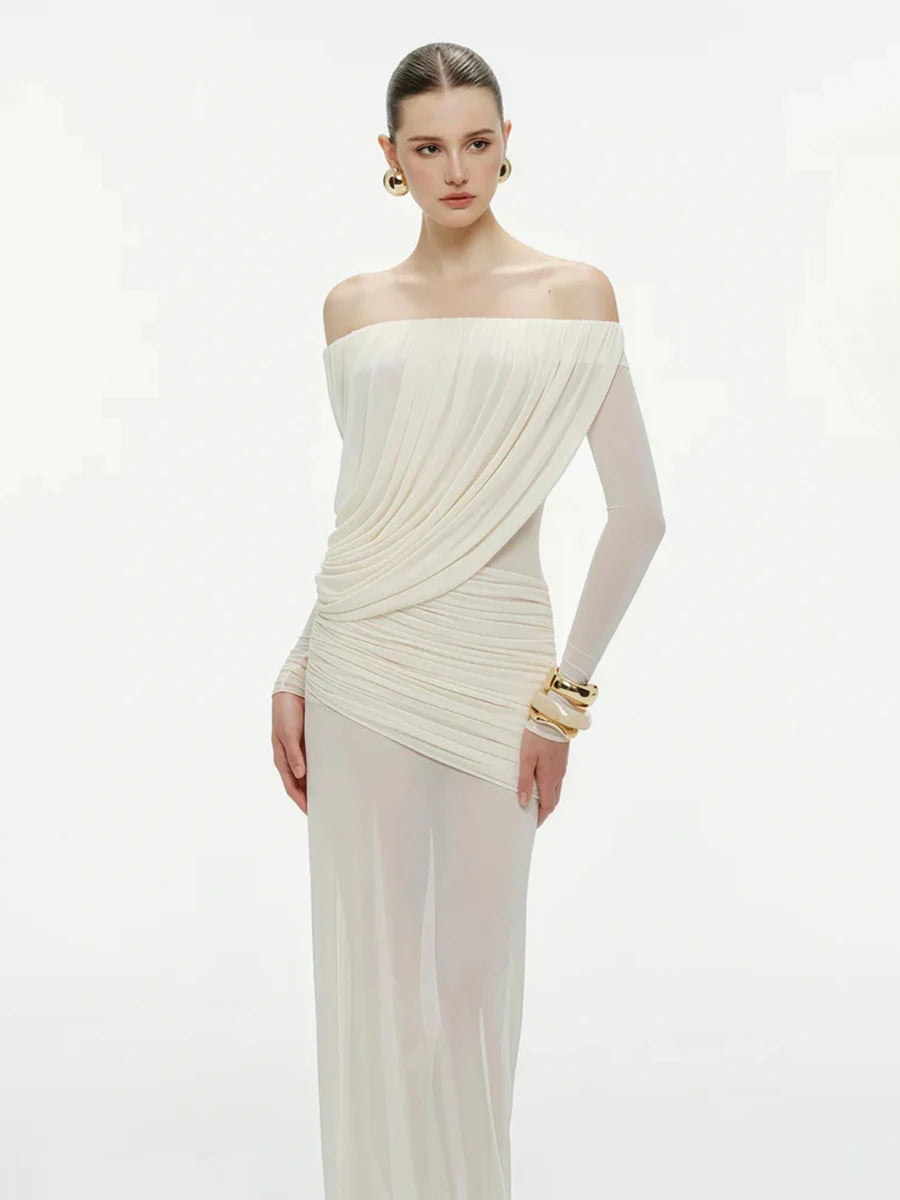 Woman wearing a white off-shoulder gown on a light gray background