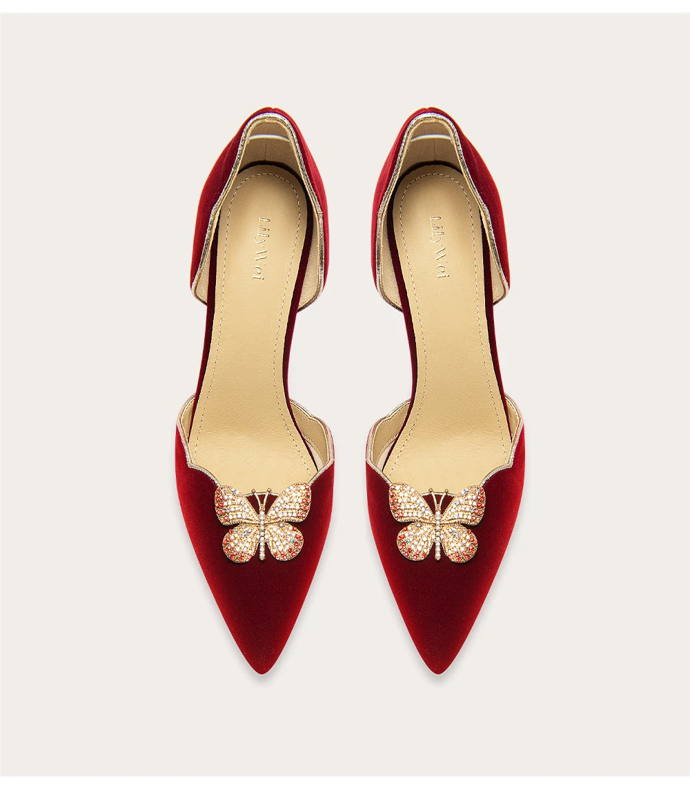 Red high-heeled shoes with decorative elements on a white background