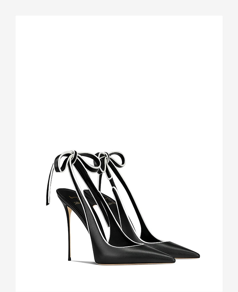 Black high-heeled shoes with ankle ties on a white background