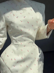 White dress with floral pattern on a dark background