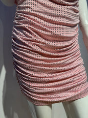 Pink dress with black polka dots on a mannequin against a white background