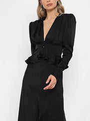 Model wearing black v-neck peplum top with skirt