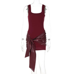 Maroon dress with a draped design on a mannequin against a white background