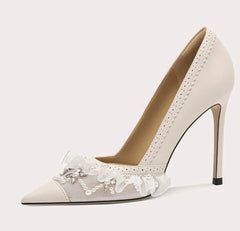 High-heeled shoe with lace details on a light gray background