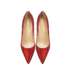 Pair of red high-heeled shoes with embellishments