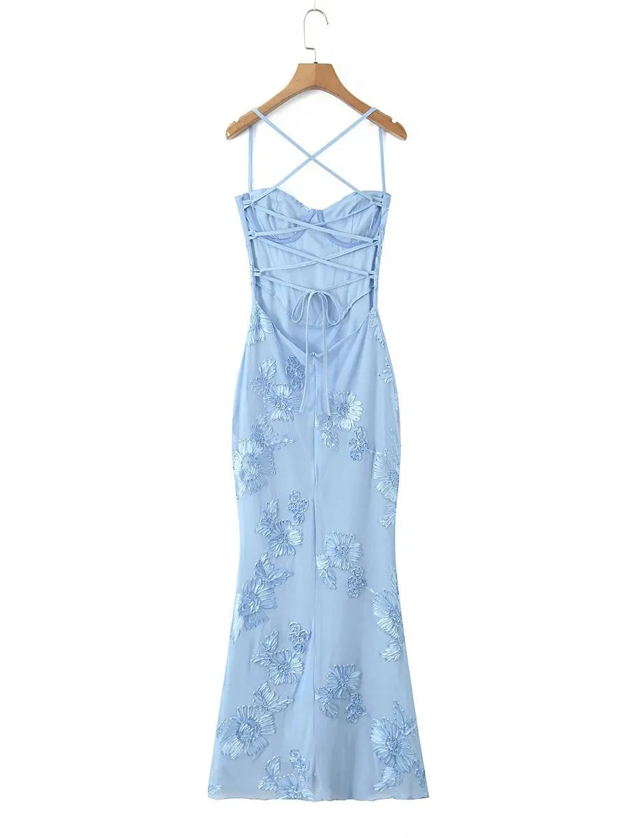 Light blue dress with floral embroidery on a hanger against a white background