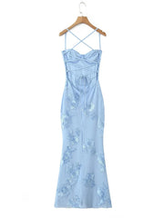 Light blue dress with floral embroidery on a hanger against a white background