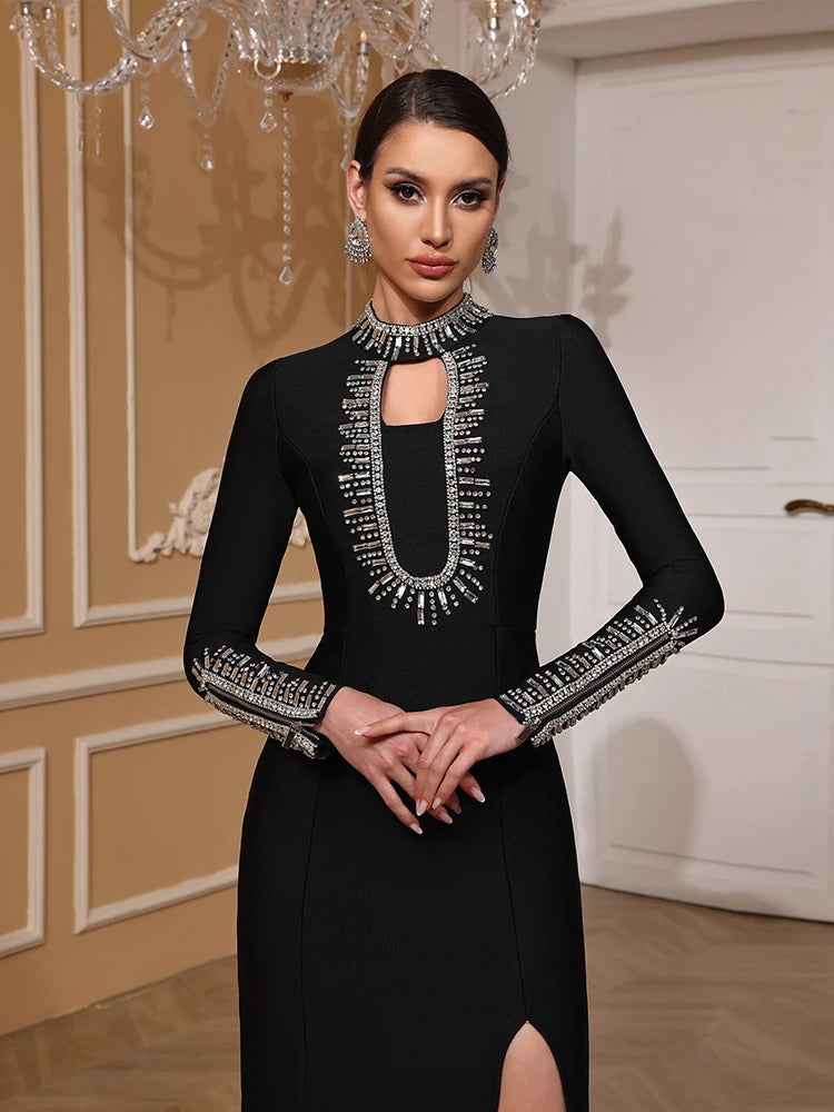 Woman wearing a black dress with intricate silver detailing in an elegant indoor setting.