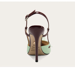 High-heeled shoe with a green sole and brown strap on a white background