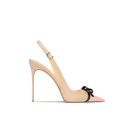 Beige high-heeled shoe with a pink toe cap and black bow on a white background