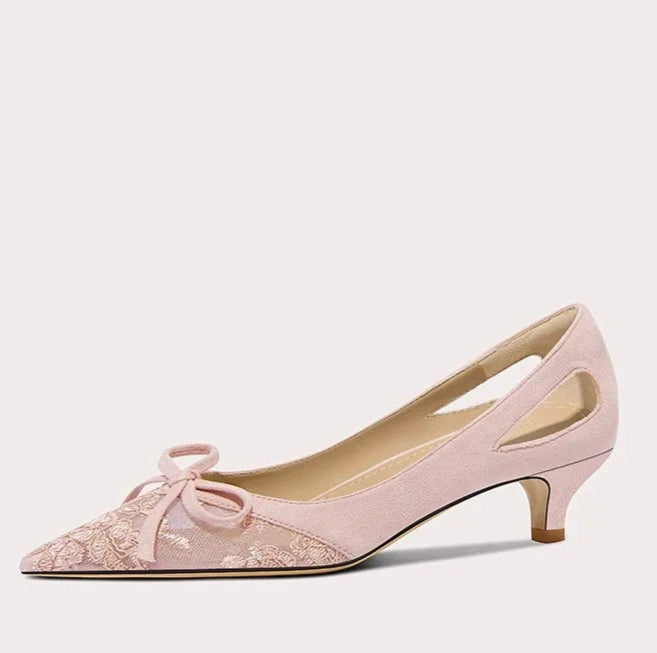 Pink high-heeled shoe with a bow on a white background