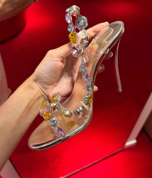 Gemstone transparent stiletto heel held in hand