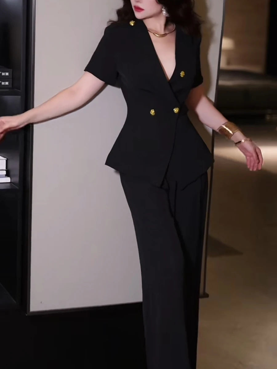 Woman wearing a black suit with gold buttons in an indoor setting