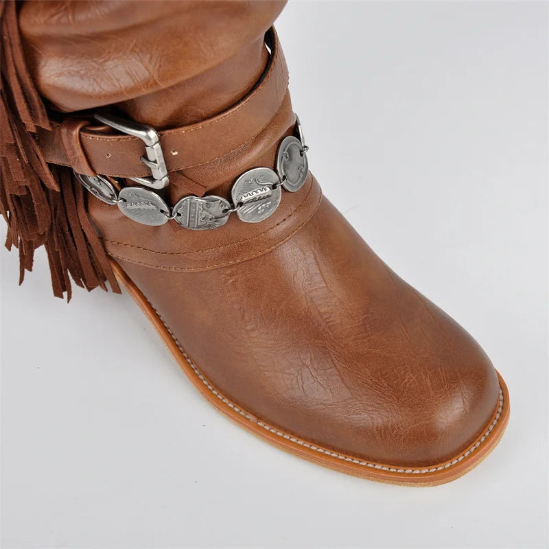Close-up of buckle and coin detail on brown fringe boots