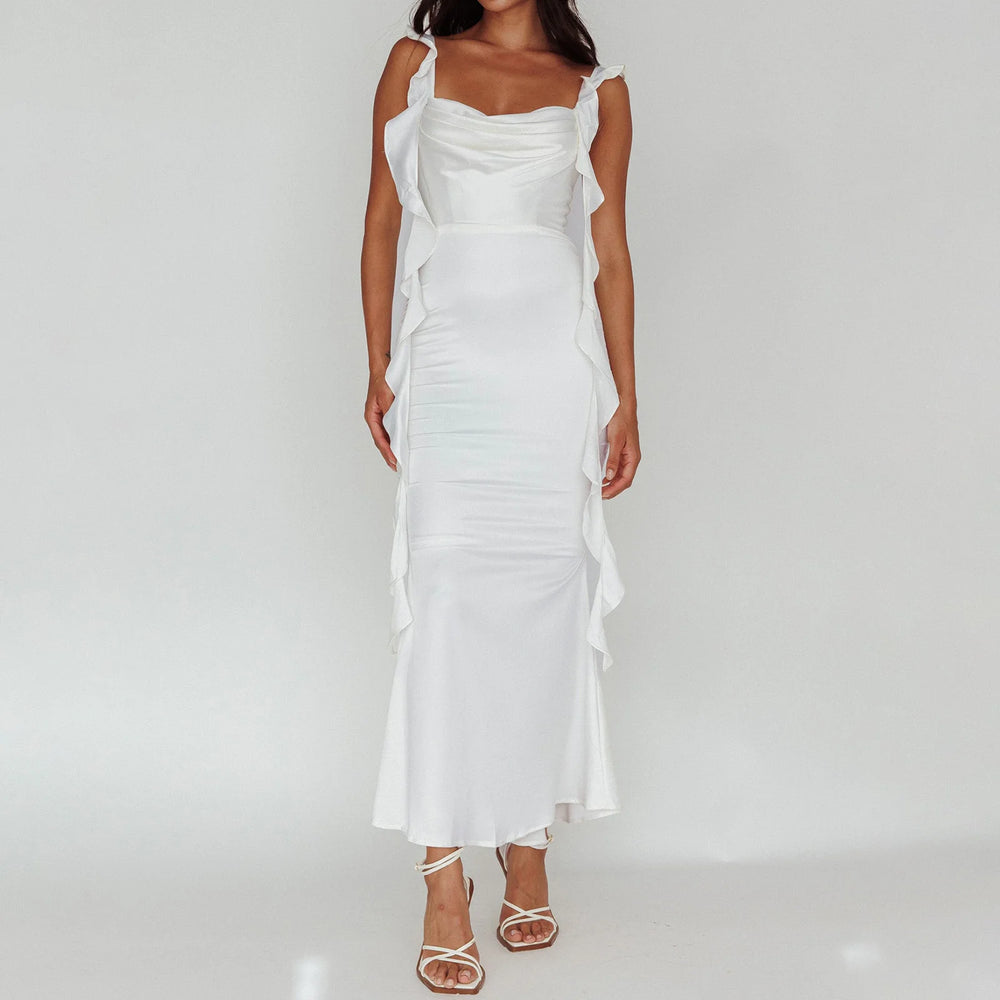 White dress with ruffled sleeves on a plain background