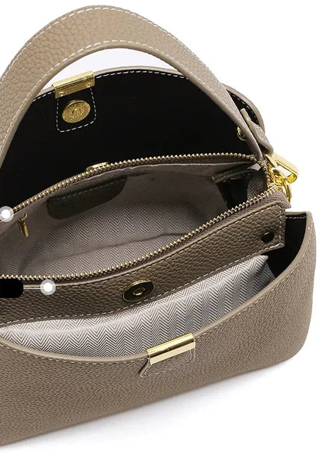 Brown handbag with gold accents on a white background