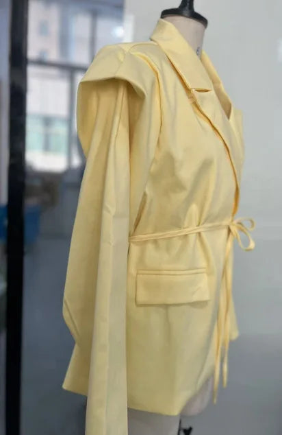 Yellow jacket on a mannequin against a blurred indoor background
