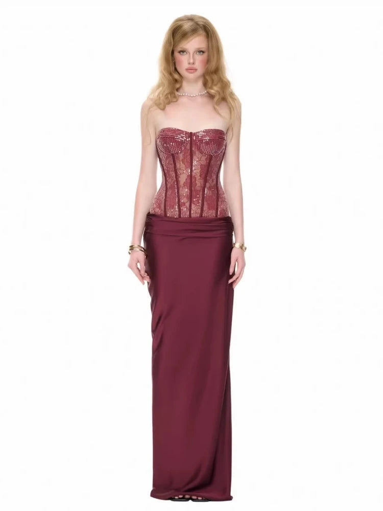 Burgundy sequin strapless corset maxi dress on a model